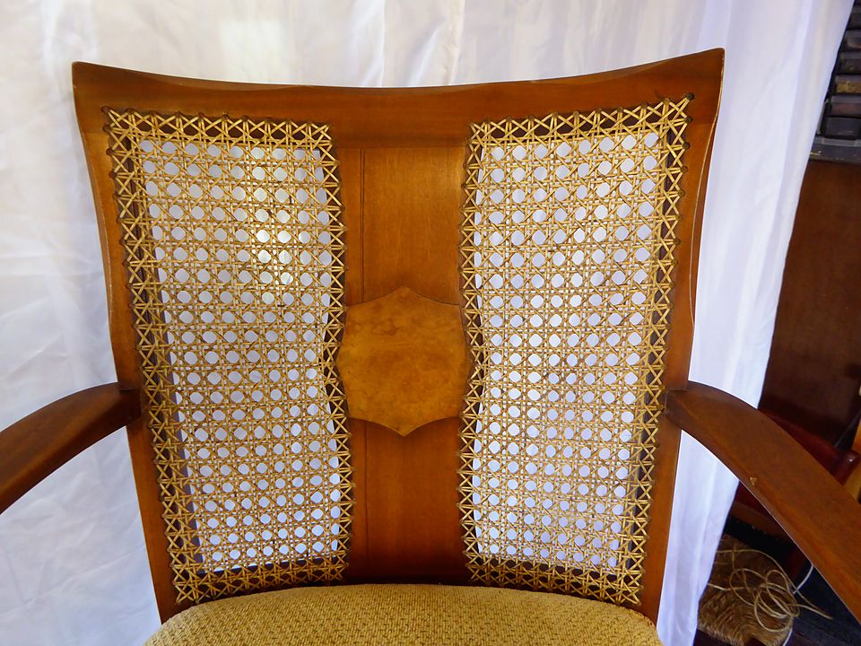 Chair back with two hand-caned panels either side of a figured centre splat