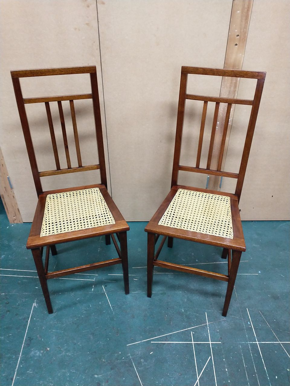 Pair of slender bedroom chairs with newly hand-caned seats